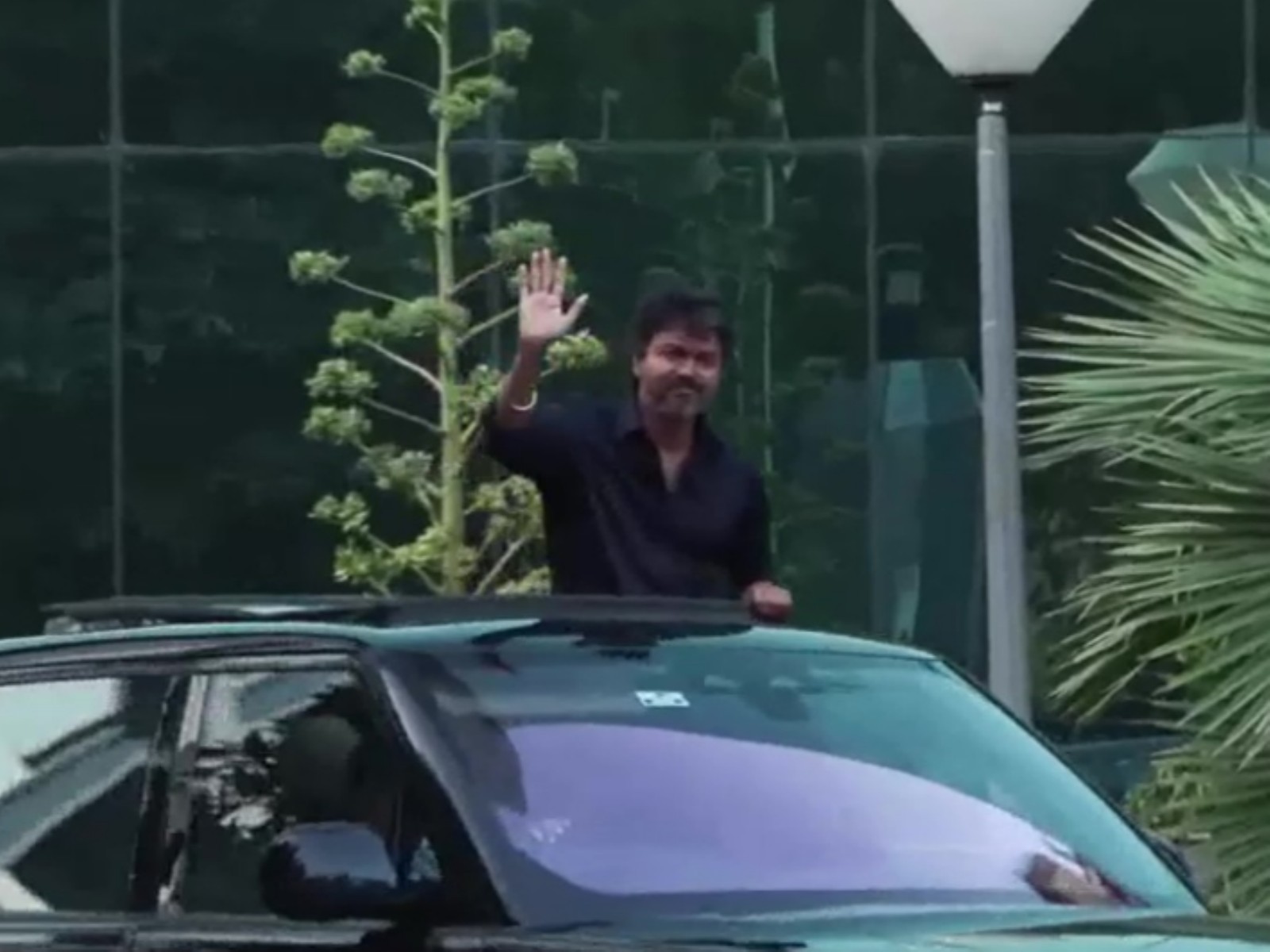 Waving from his car’s sunroof, TVK Chief Vijay leaves from CBI headquarters after questioning in Karur stampede case