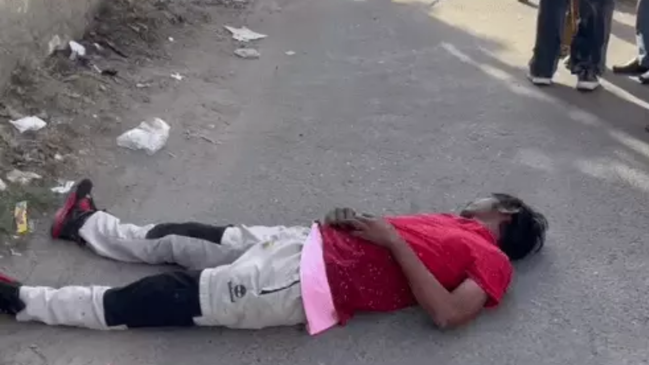 The body of the young man lying on the road