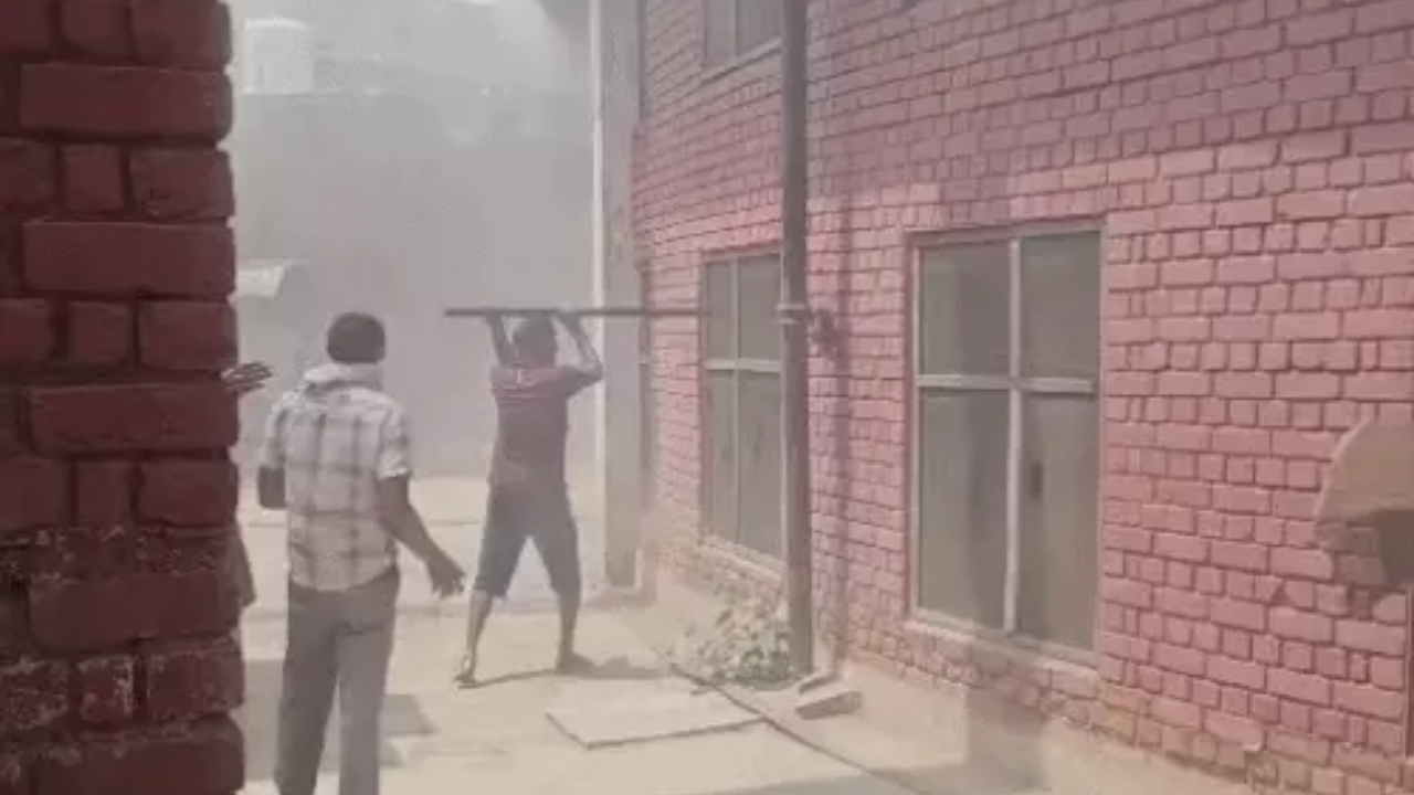 Employees breaking the window to put out the fire.